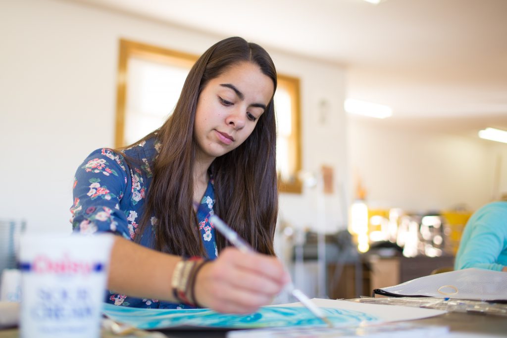 Grace College Art Major Student painting in art studio.