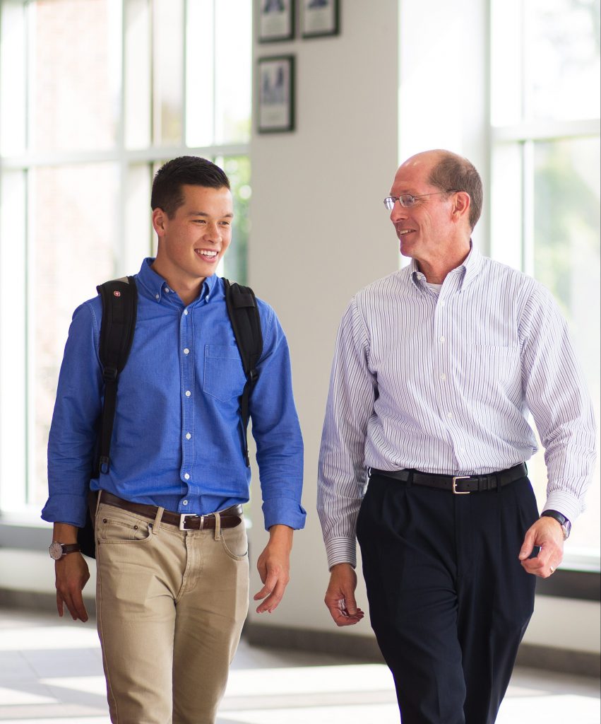 Dr. Bingham and student walking together