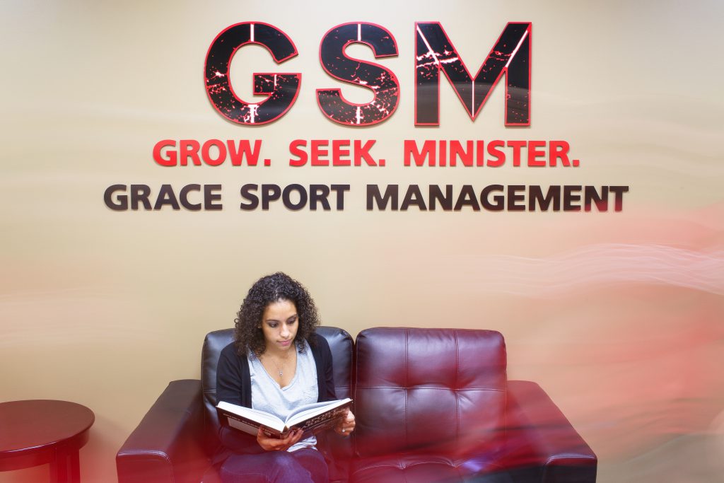 Student with Grace sport management sign
