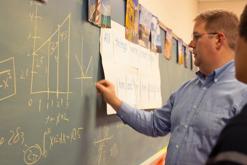 Math Education Major Professor writing math on a chalk board