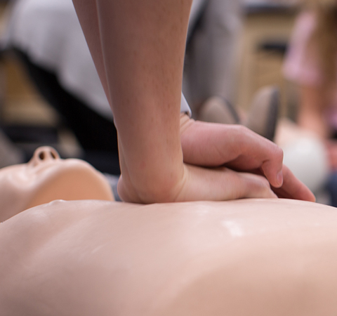 Student performing CPR on a dummy