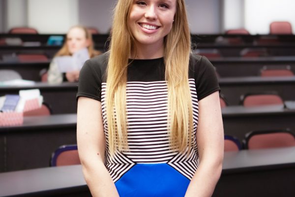 Student in classroom smiling