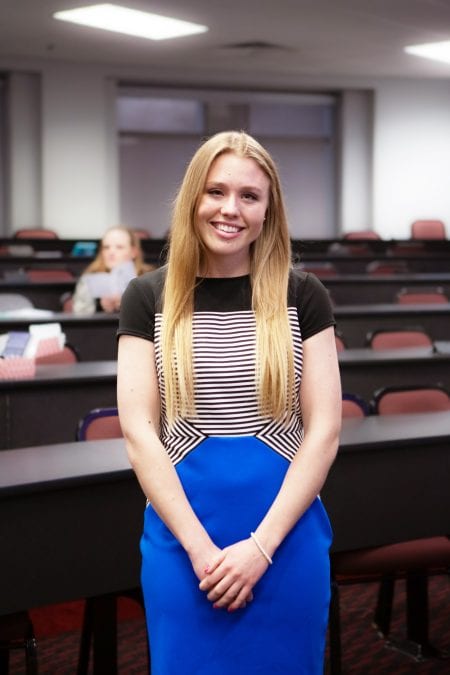 Student in classroom smiling