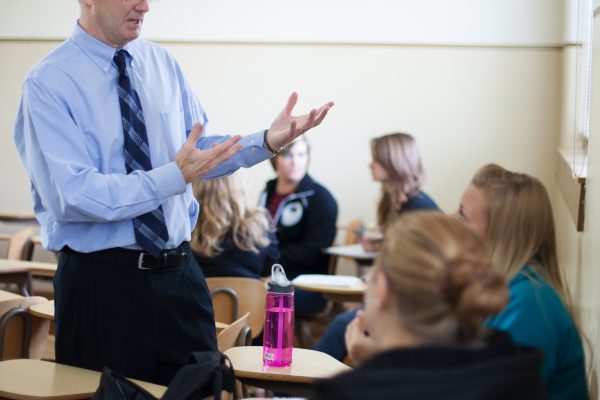 Professor in class explaining to students
