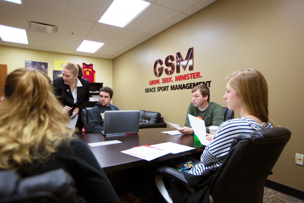 Students with professor in the grace sports management room