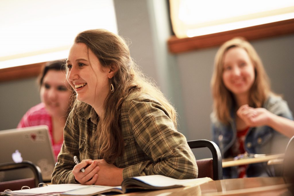 student in class smiling