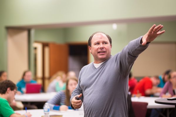 Professor teaching with an outstretched arm