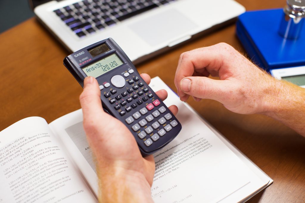 Man holding a calculator