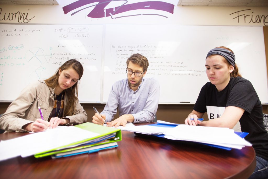 Students with professor at round table