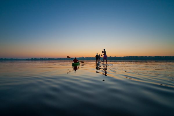 Students paddle boarding on the lake