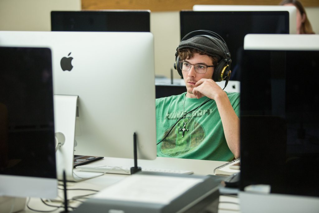 Student in computer lab wearing headphones