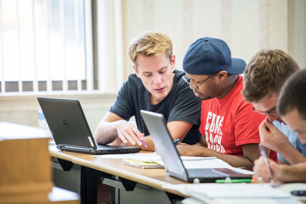 Mathematics and Computer Science Students in class working together