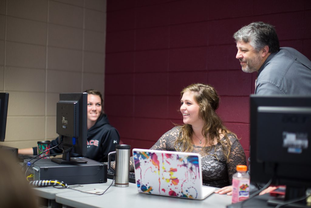 Students in computer lab with professor of Information Systems Major