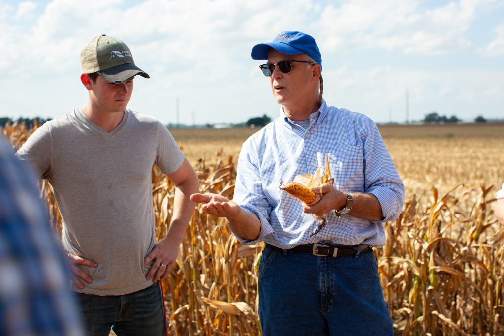 Tobe Forshtay Agribusiness Degree Class at Tom Farms. Farmer and student looking at corn