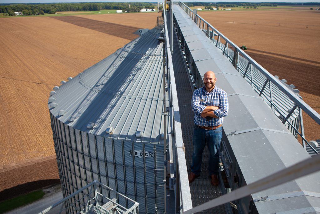 Professor of Agricultural business class on top of the silos