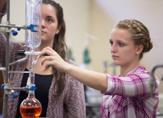 Chemistry degree Students in lab with test tubes