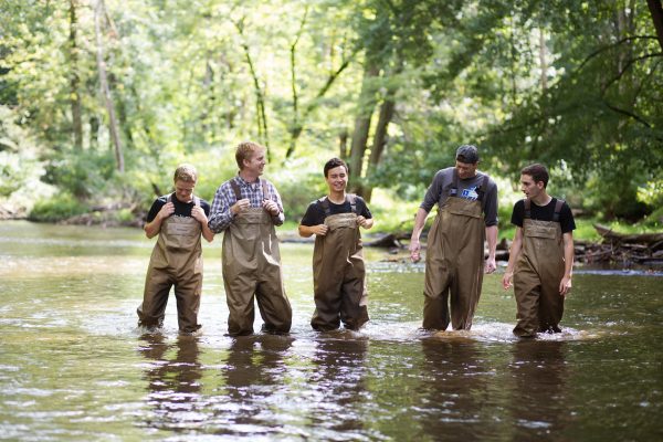 Students walking through stream for Ecology