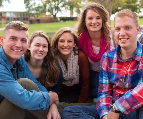 Students hanging out on a green space on campus