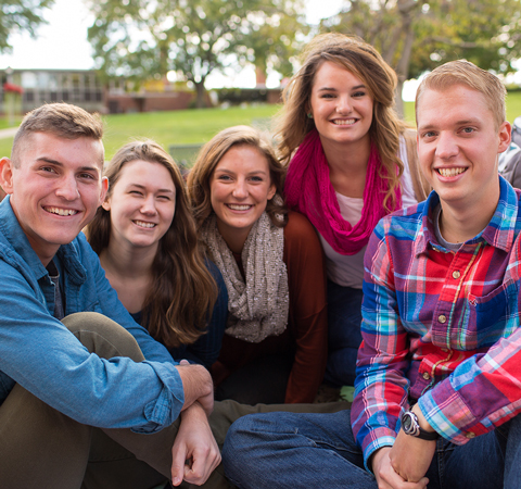 Students hanging out on a green space on campus