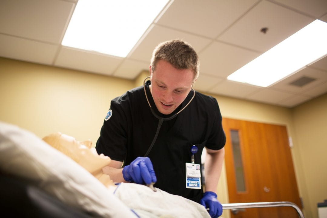 Student working on mannequin in Nursing major