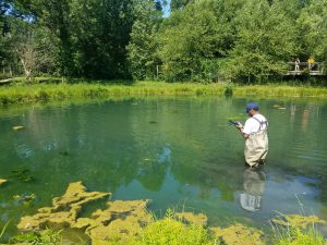 Christopher Moseti gathers water samples