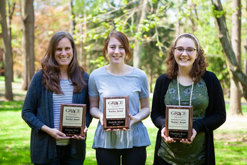 Students holding education awards