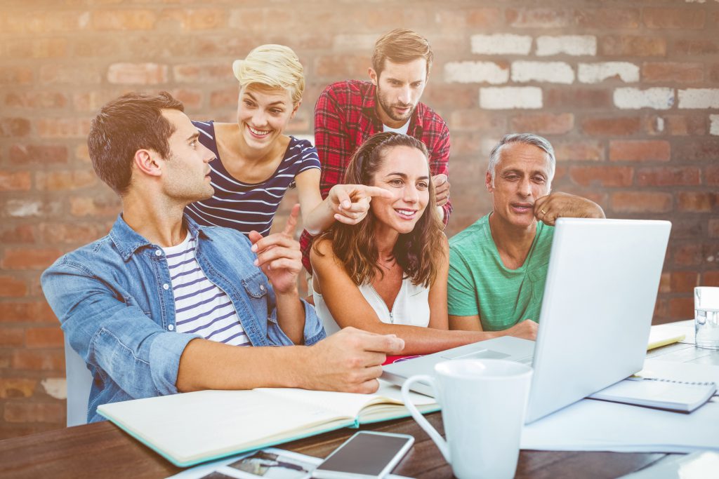 business team using laptop in meeting