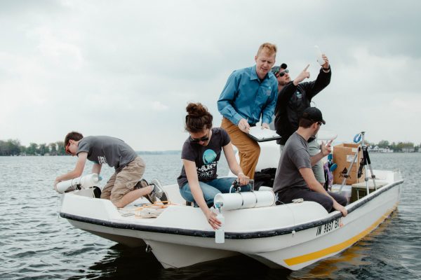 The Lilly Lakes and Streams team works in a boat.