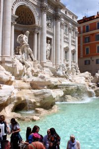 The Trevi fountain at noon, when many tourists crowd around the landmark. 