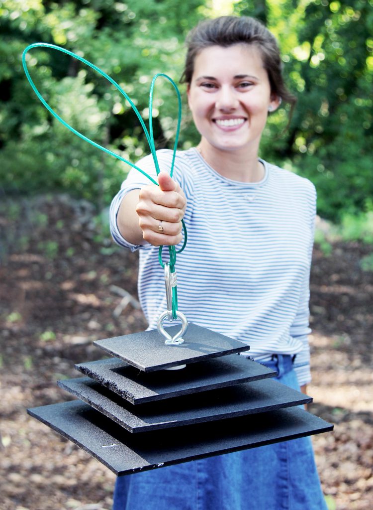 Research team member holds a zebra mussel sampler.