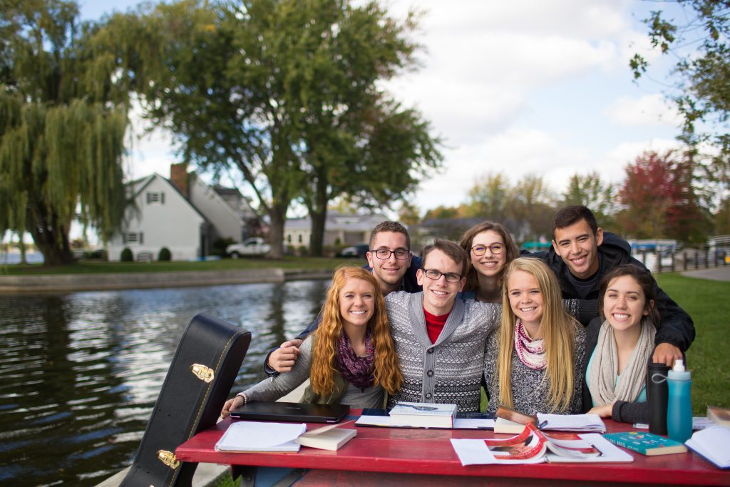 Students at the lake at a picnic table