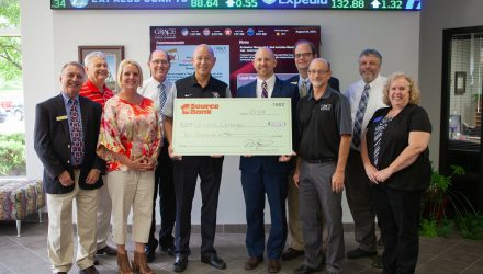 Business professors and Dr. Bill Katip presented with a check from 1st Source Bank