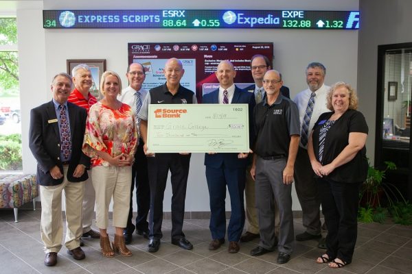 Business professors and Dr. Bill Katip presented with a check from 1st Source Bank