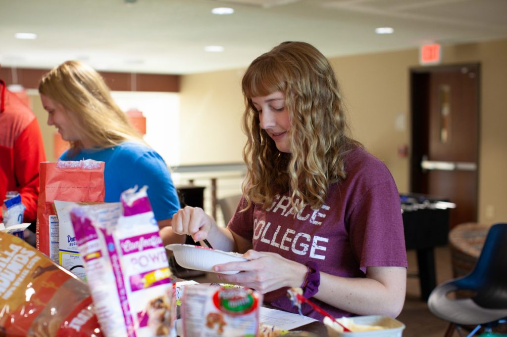 Students cooking in Omega kitchen
