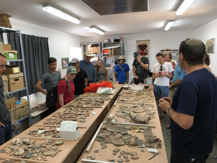 Students in Israel standing around archeological finds