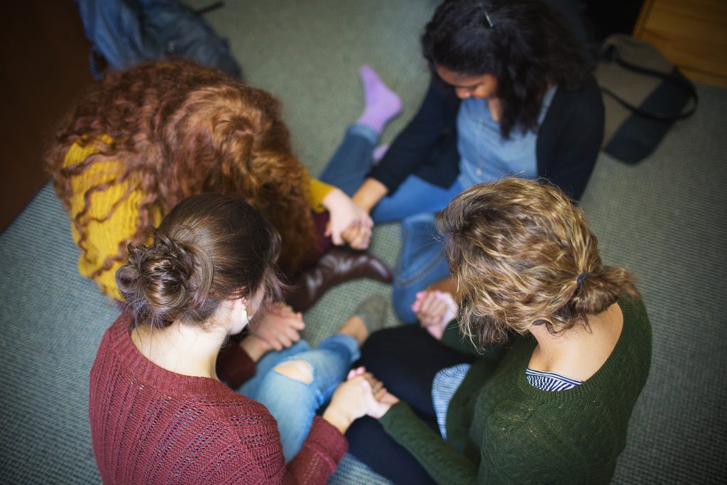 Students praying in a circle