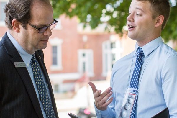 Student talking to professor outside