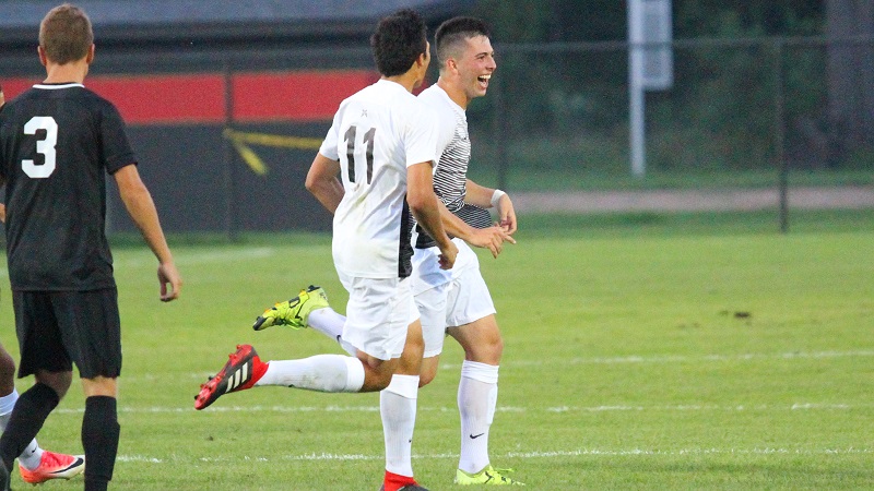 Men's soccer athletes celebrate together