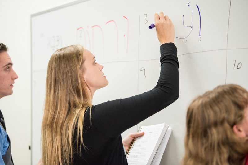Student writing in Hebrew
