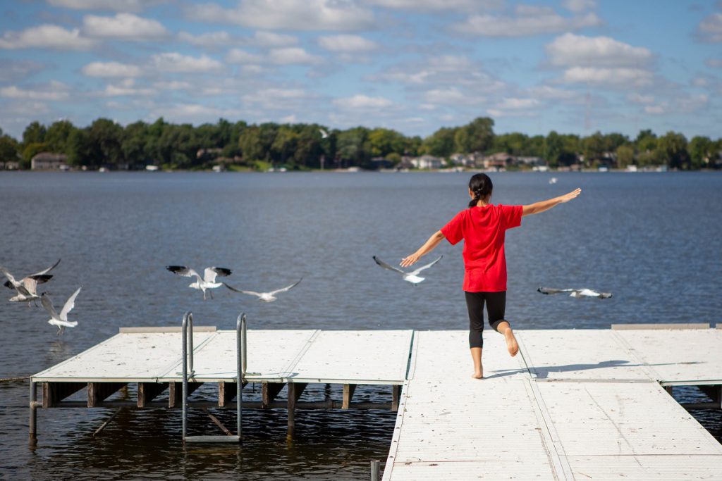 Student on the dock at the lake