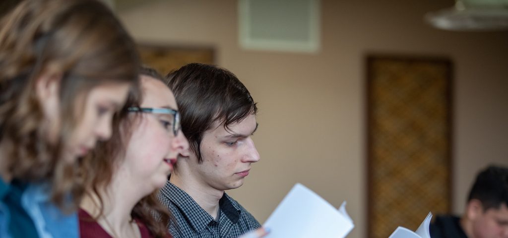 Students at Communitas reading off paper