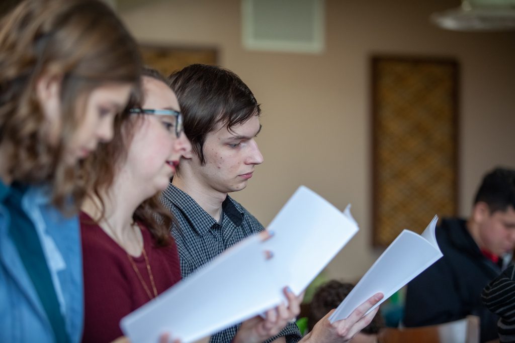 Students at Communitas reading off paper