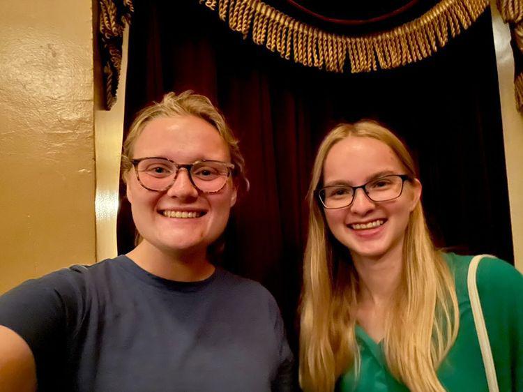 Two summer interns smiling together during a night out in New York City, building friendship and living out faith through shared experiences.