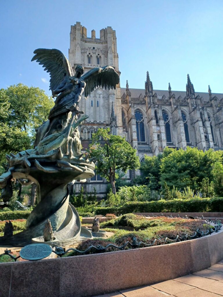 Majestic cathedral and angel statue in New York City, captured during a summer internship exploring faith, art, and architecture while living out your faith.