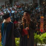 Grace College looks at the impact of AI on higher education. Is a college degree worth it? Learn about our Christian College in Indiana. Student receives diploma at commencement.